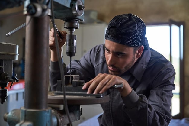 A close-up of an apprentice working on a complex machine in a factory setting. The apprentice is wearing safety glasses and appears focused on the task. The machine is modern and well-maintained, indicating a high-tech environment.