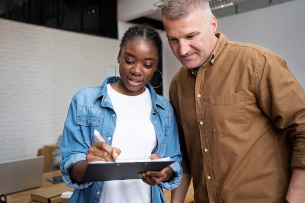 An apprentice and a mentor reviewing technical drafts on a tablet in a brightly lit office. The apprentice is taking notes, and the mentor is explaining details, both are wearing professional attire.