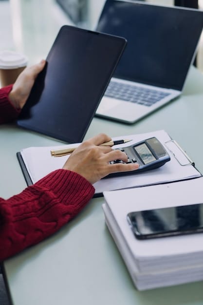 A close-up shot of a person's hands using a calculator and reviewing financial documents, highlighting the importance of accurate VAT calculations and record-keeping for online retailers in the UK.
