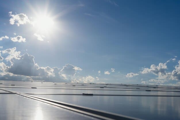 A close-up of solar panels glistening in the sunlight, reflecting the sky and clouds.