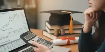 Student analyzing federal student loan interest rate changes on a laptop with a calculator.