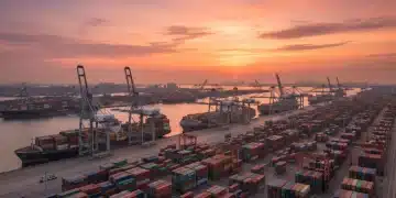Vibrant sunset over a busy US container port with cargo ships and cranes